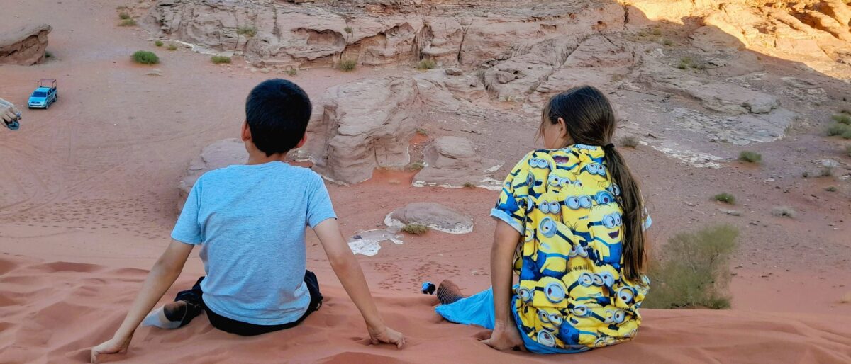 4x4 Jeep driving through the red desert landscape and rock formations of Wadi Rum