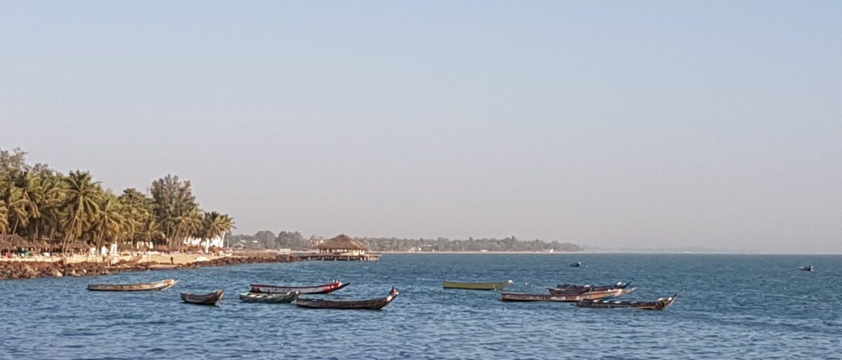 Boat approaching the lush, green Djilapao Island on the Casamance River