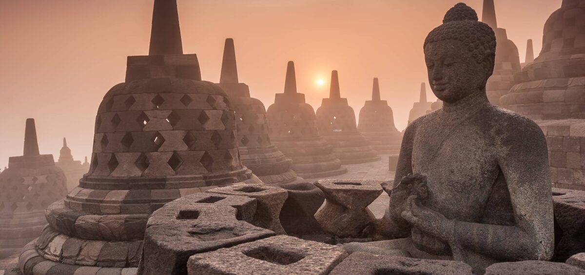 Borobudur Buddhist temple in Central Java with stupas silhouetted against the sky