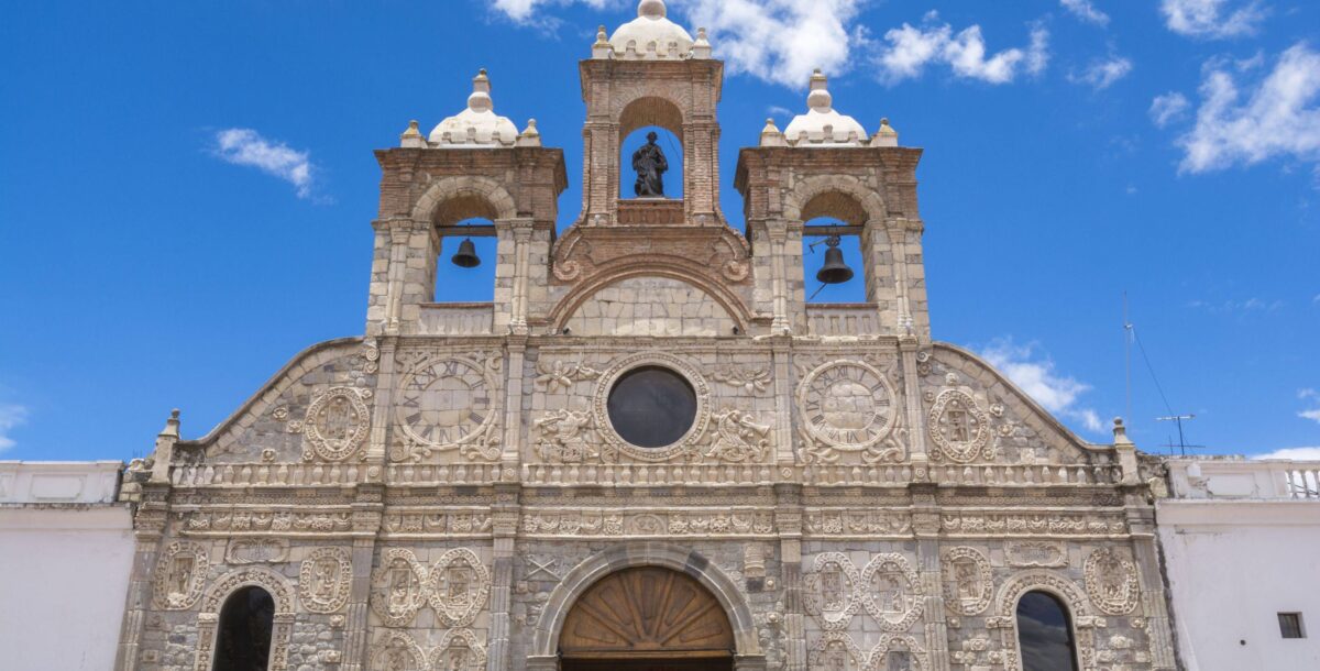Busy Andean market in Guamote with locals in traditional dress trading goods