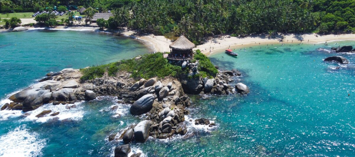 Cabo San Juan beach in Tayrona National Park with turquoise water, palm trees and rocky headlands