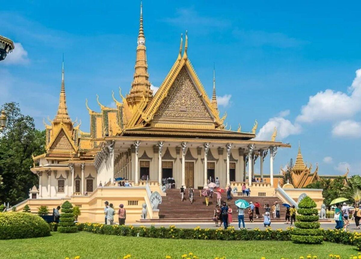 Cambodian Royal Palace complex in Phnom Penh with golden roofs shining under a blue sky
