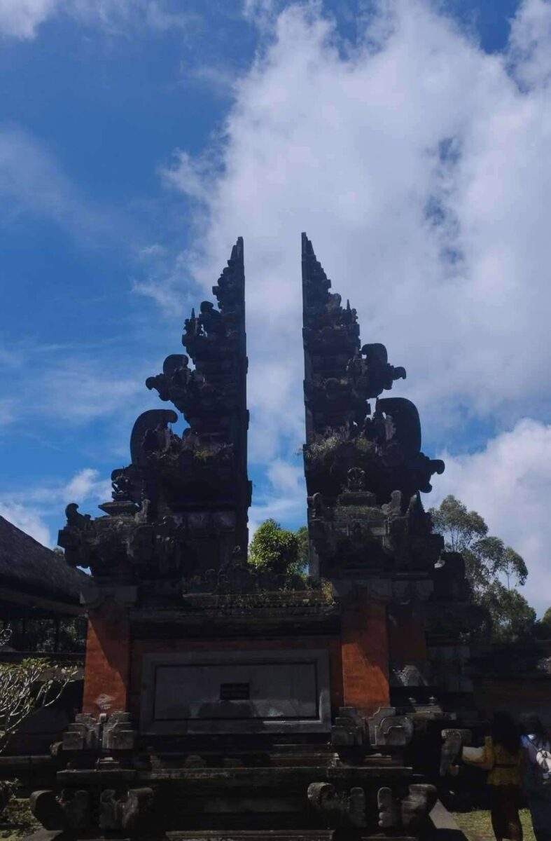 Car driving along a coastal road in Bali at sunrise heading towards the airport
