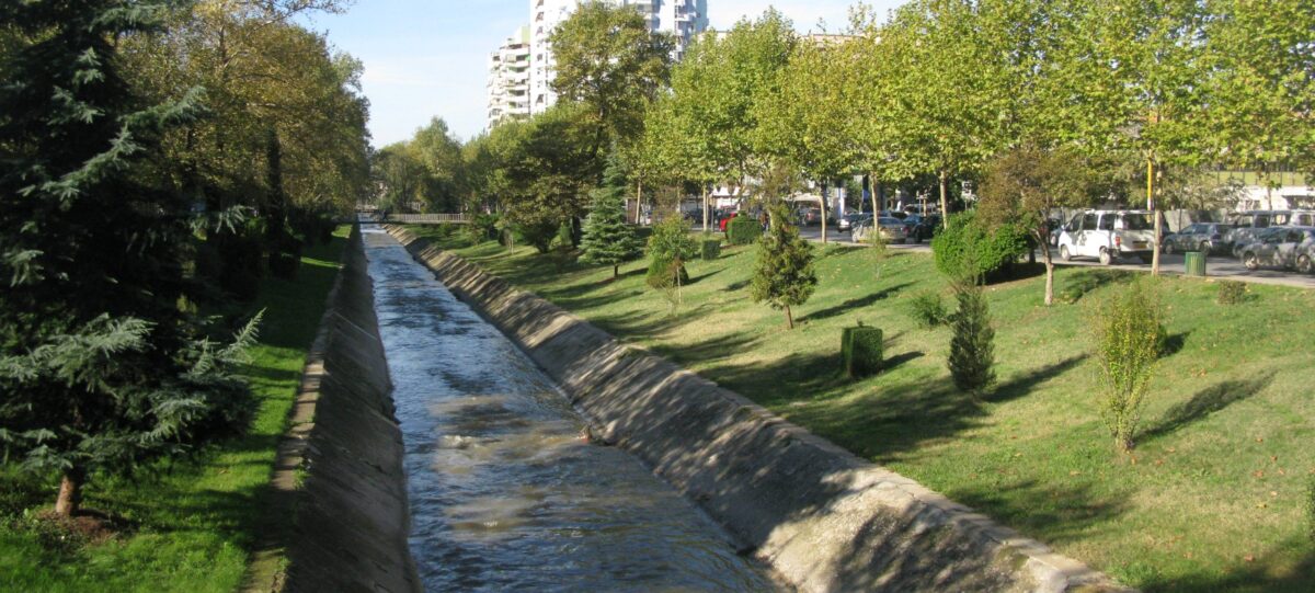 Central Tirana cityscape with Skanderbeg Square, colorful buildings, clock tower and mountains in the background
