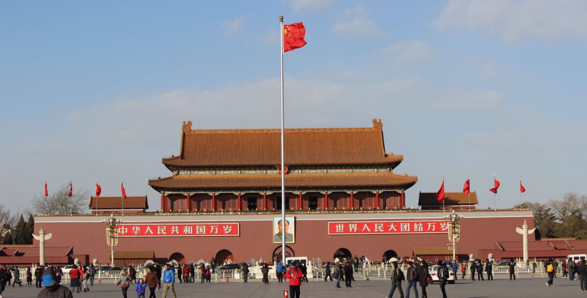Children exploring the Forbidden City in Beijing with their parents, looking at red palace walls and golden roofs
