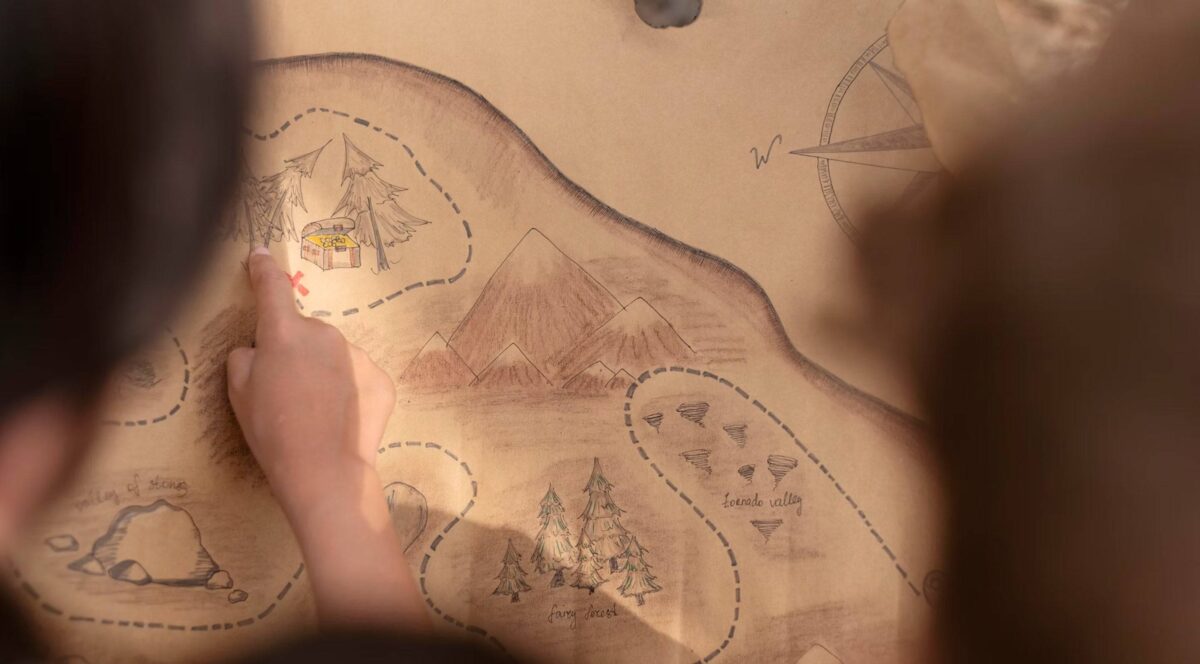 Children on a guided treasure hunt holding a map in the tropical countryside near Ubud