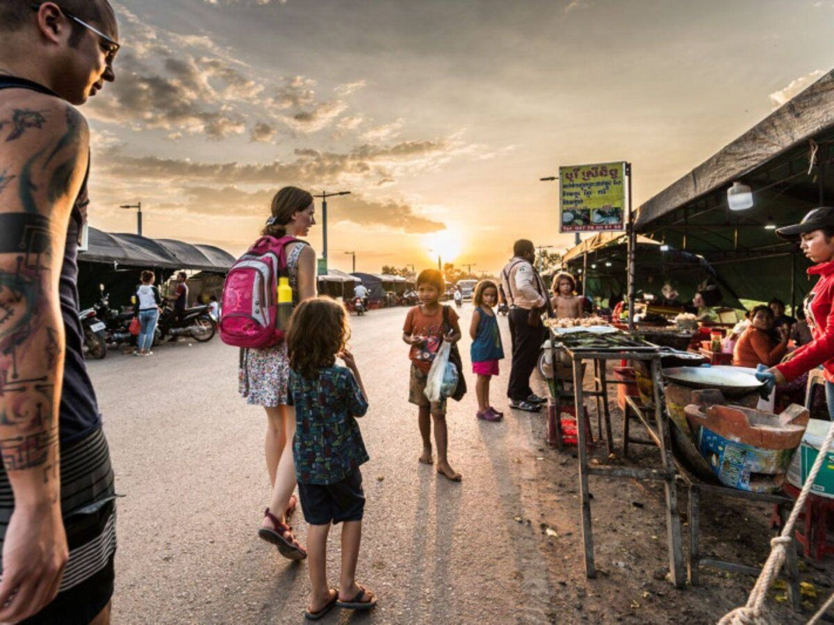Children playing mini-golf on a course with miniature Angkor temple models near Siem Reap