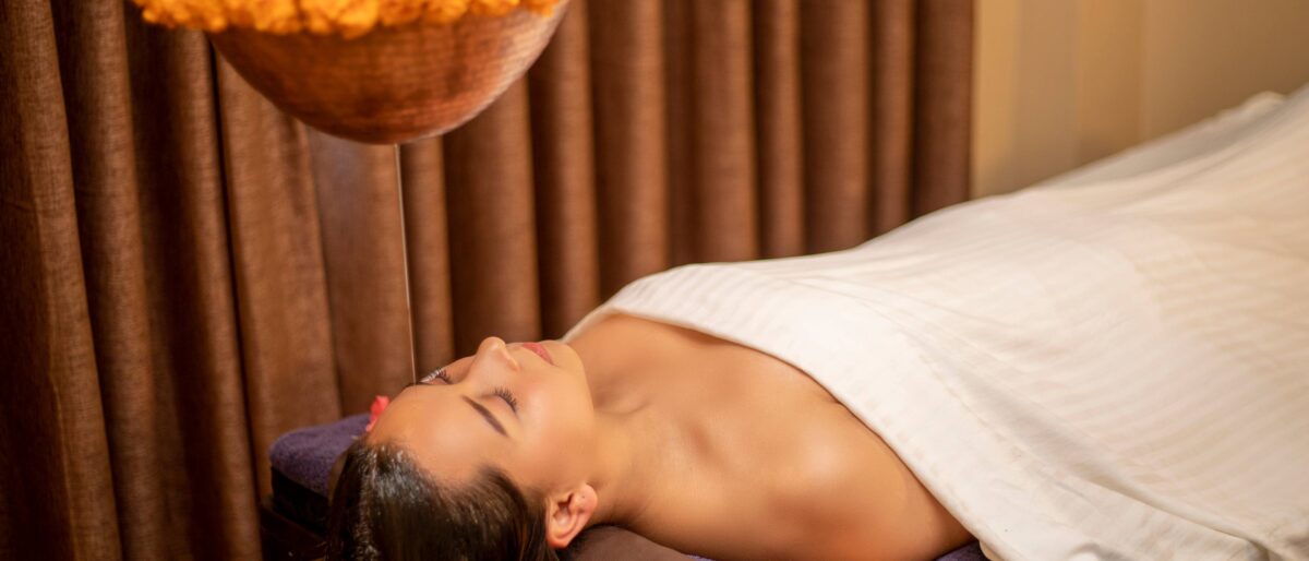 Close-up of a wellness session in Kathmandu with a traditional metal singing bowl and soft natural lighting