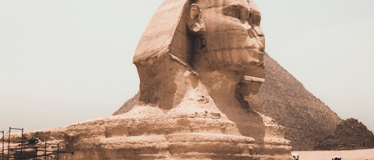 Close-up view of the Great Pyramid of Giza and the Great Sphinx under a clear blue sky