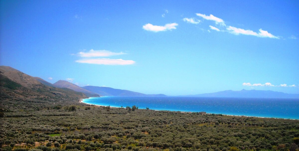 Coastal road above the Albanian Riviera with turquoise sea and rocky coves below