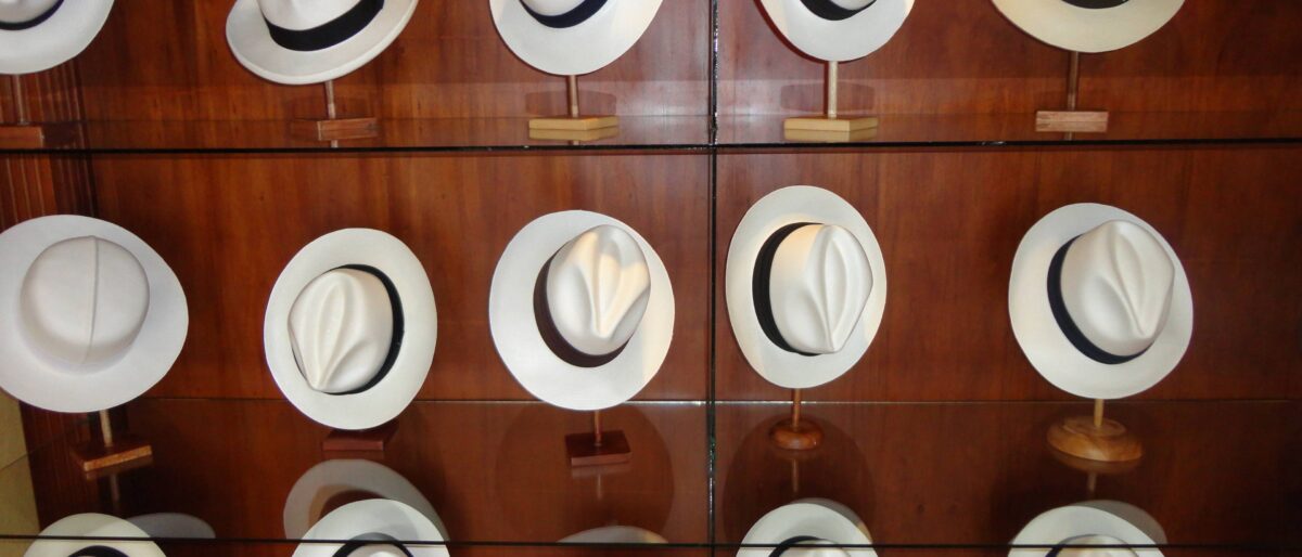 Colonial street in Cuenca with balconies, cobblestones and the domes of the cathedral in the background