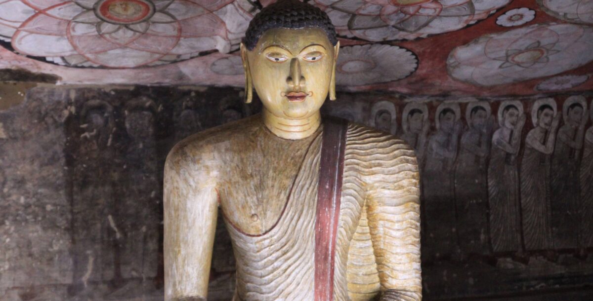 Colorful Buddha statues and wall paintings inside the Dambulla Cave Temple in Sri Lanka