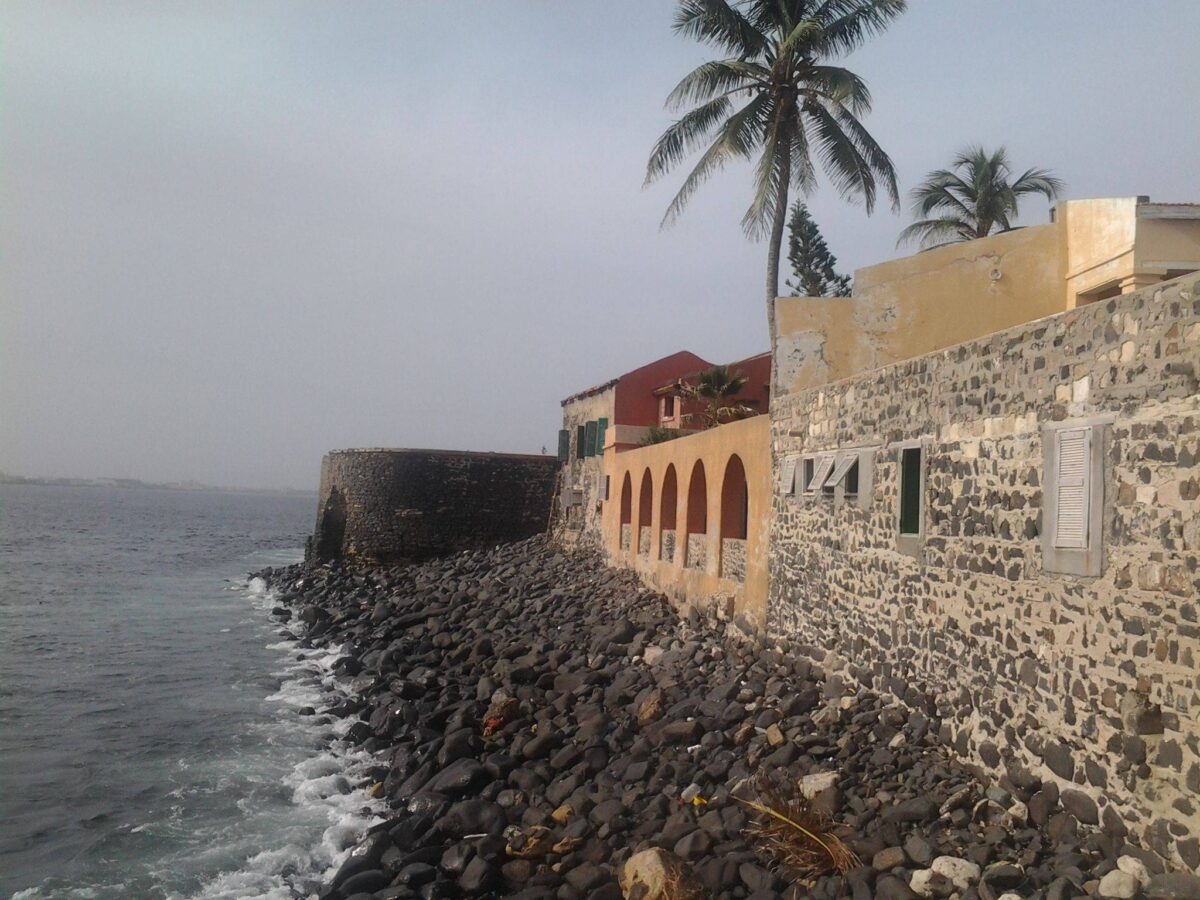 Colorful colonial houses with bougainvillea on a cobbled street on Gorée Island in Senegal