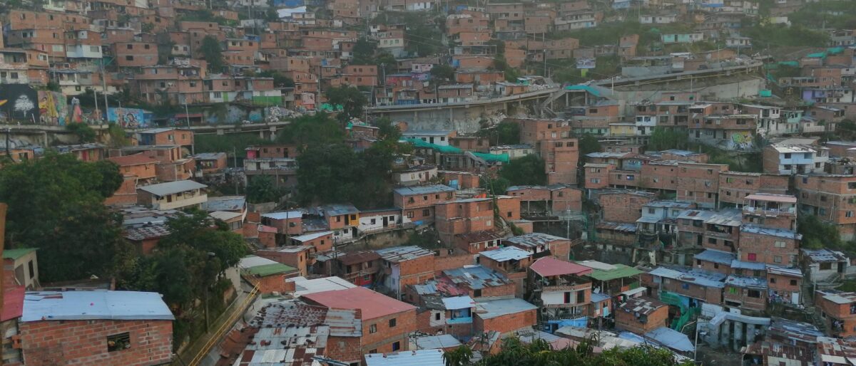 Colorful graffiti murals and outdoor escalators in Medellín’s Comuna 13 district