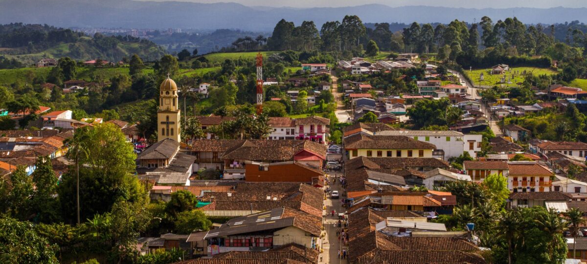 Colorful wooden balconies and houses on a steep street in Salento, Colombia’s Coffee Region