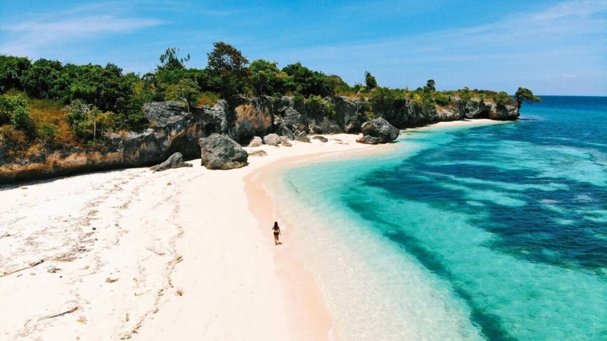 Contrast of black-clothed Kajang villagers and bright tropical surroundings, followed by a white-sand beach and blue sea in Bira