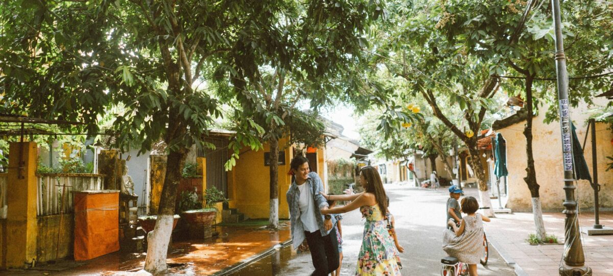 Couple enjoying a romantic candlelit dinner in a tent overlooking rice fields near Hoi An at sunset