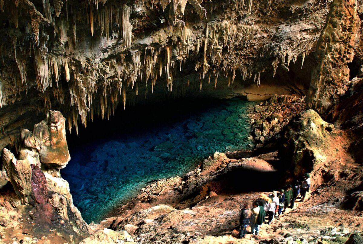 Deep blue underground lake inside Gruta do Lago Azul cave near Bonito with limestone formations