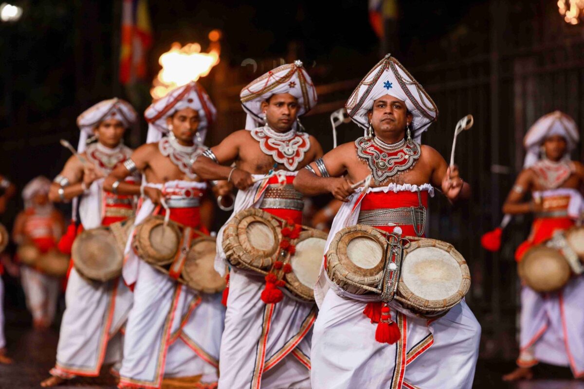 Elephants and traditional Sri Lankan dancers parading at night during the colorful Kandy Esala Perahera festival