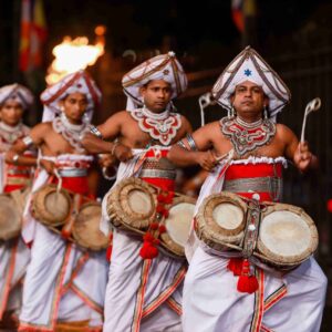 Elephants and traditional Sri Lankan dancers parading at night during the colorful Kandy Esala Perahera festival