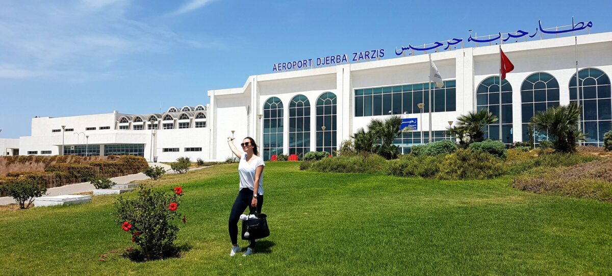 Evening arrival in Djerba with view of whitewashed houses and fishing boats in the harbor