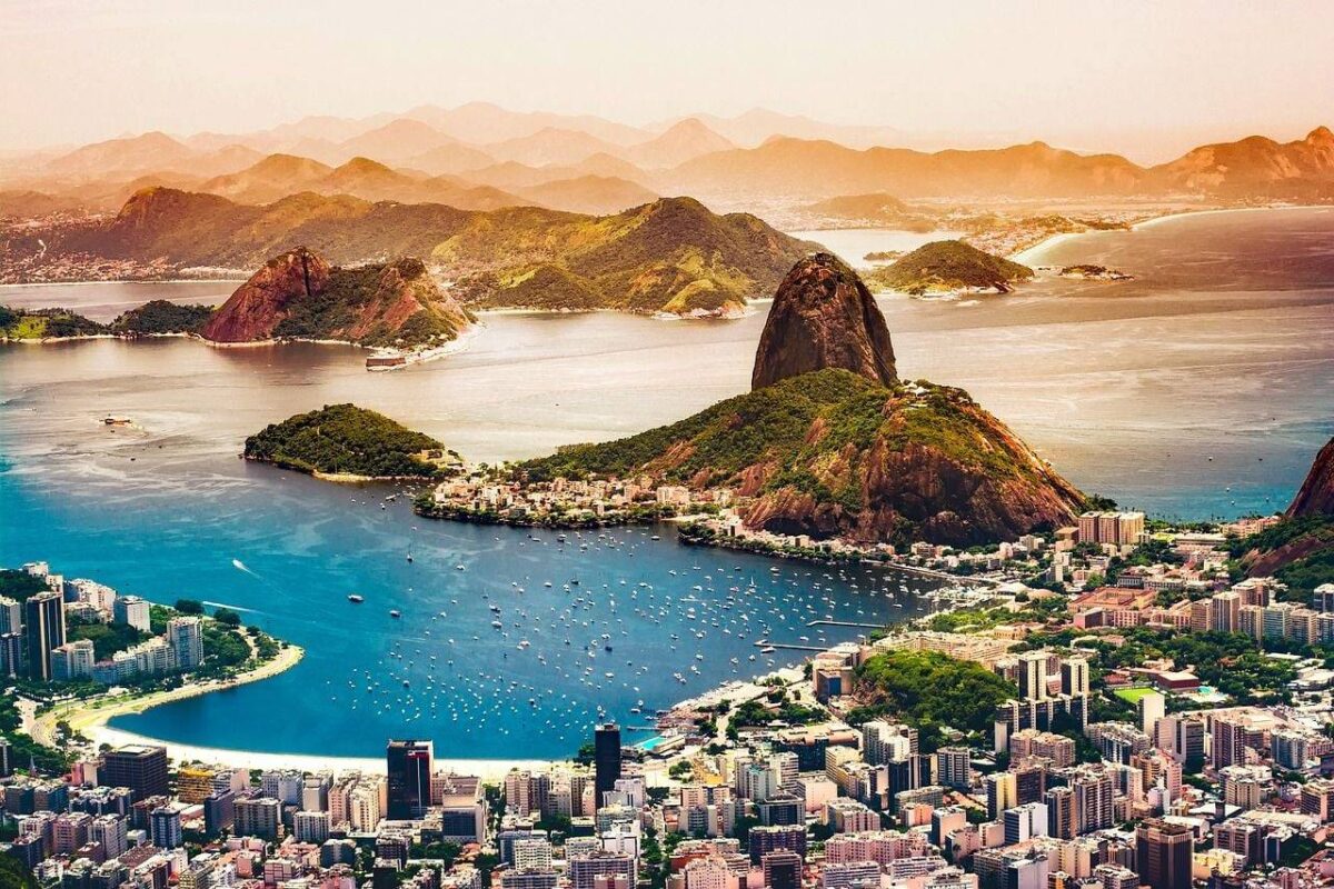 Evening view over Copacabana and Ipanema beaches in Rio de Janeiro with city lights and mountains in the background