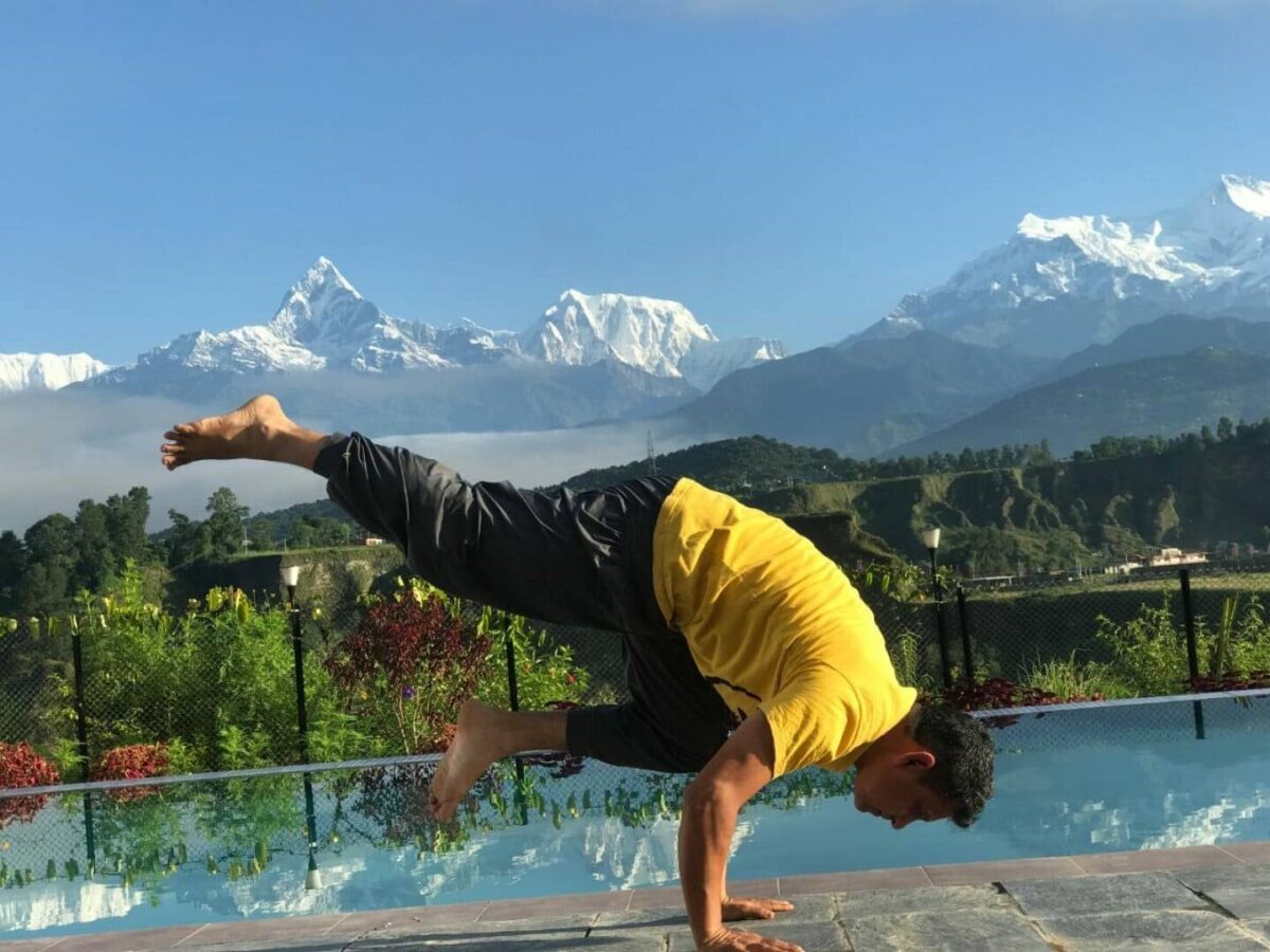 Evening view over Kathmandu city with traditional houses and distant hills under a hazy sky