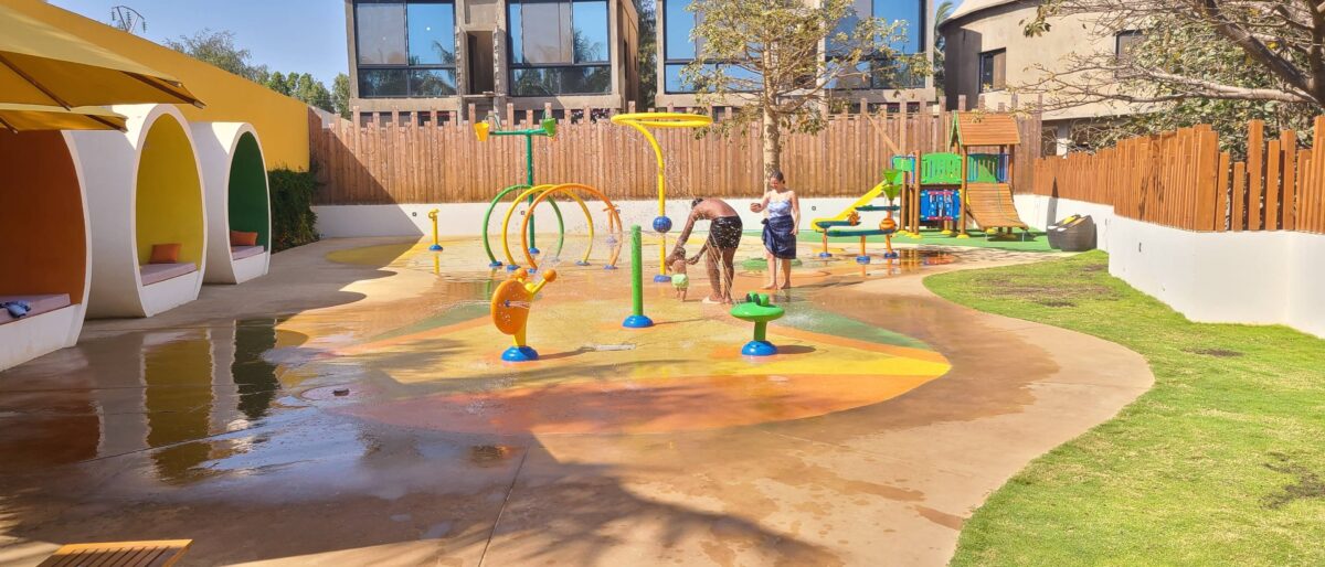 Family arriving at Blaise Diagne International Airport and driving towards Somone, Senegal, with palm trees and coastal scenery