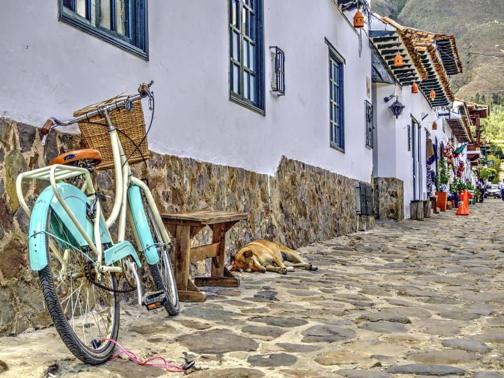 Family hiking through arid hills near Villa de Leyva with ancient rock art on stones