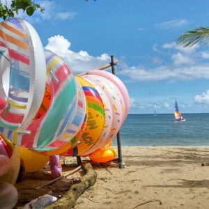 Family with children walking through lush green rice terraces near Ubud on a sunny day in Bali
