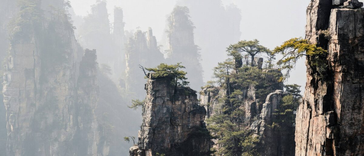 Family with young kids riding a cable car above the pillar-like sandstone peaks of Zhangjiajie’s Tianzi Mountain