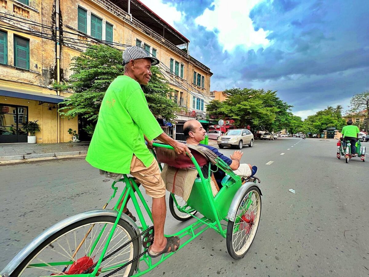 Golden roofs and ornate spires of the Royal Palace complex in Phnom Penh, Cambodia, under a bright blue sky