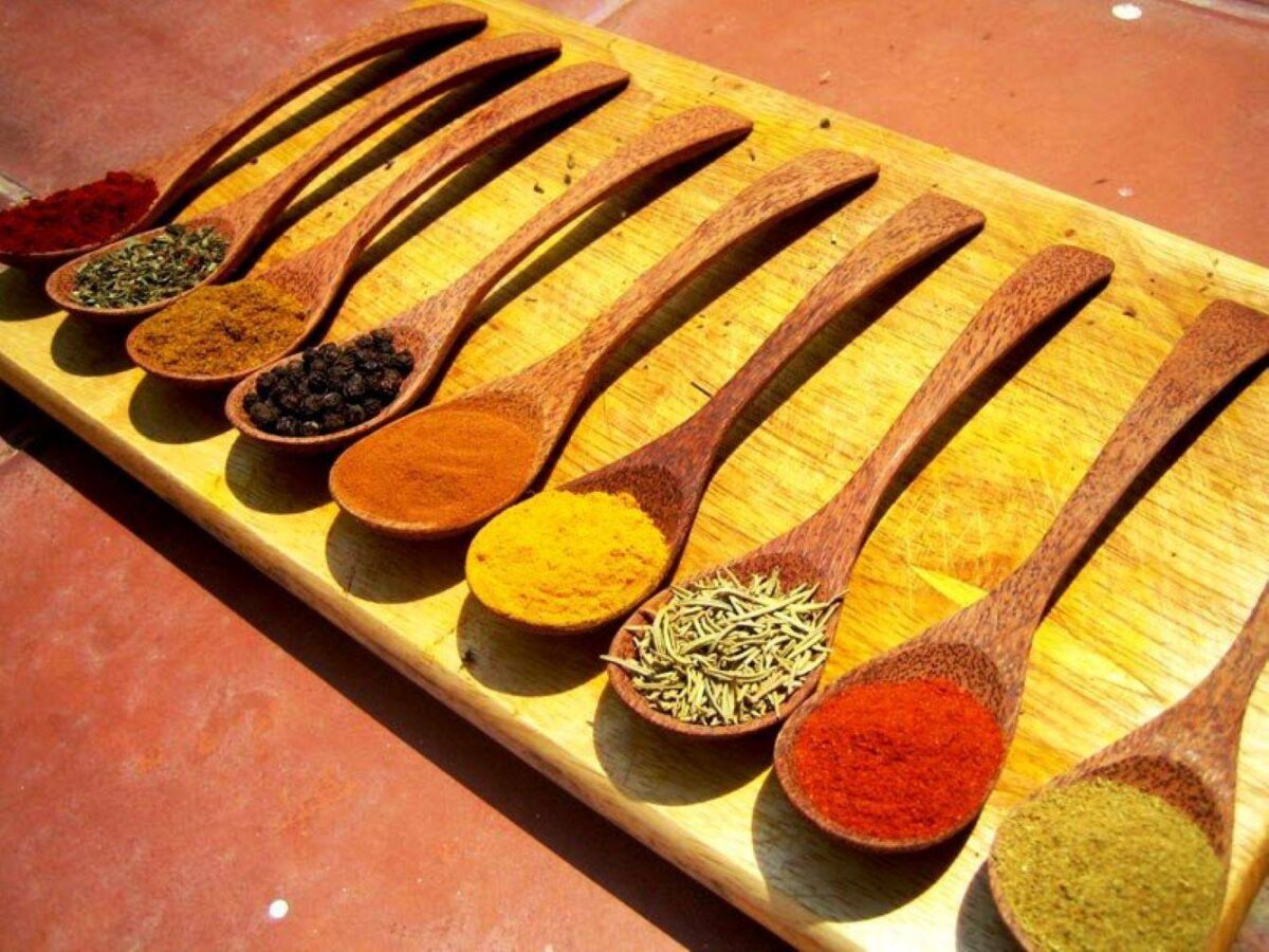 Guide showing visitors aromatic plants in a lush Sri Lankan spice garden near Matale