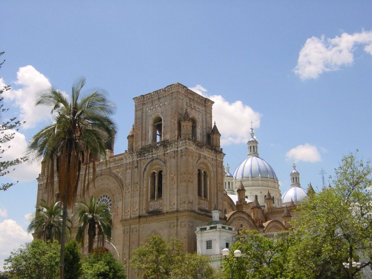 Historic center of Cuenca with colonial houses, church domes and the Tomebamba River promenade