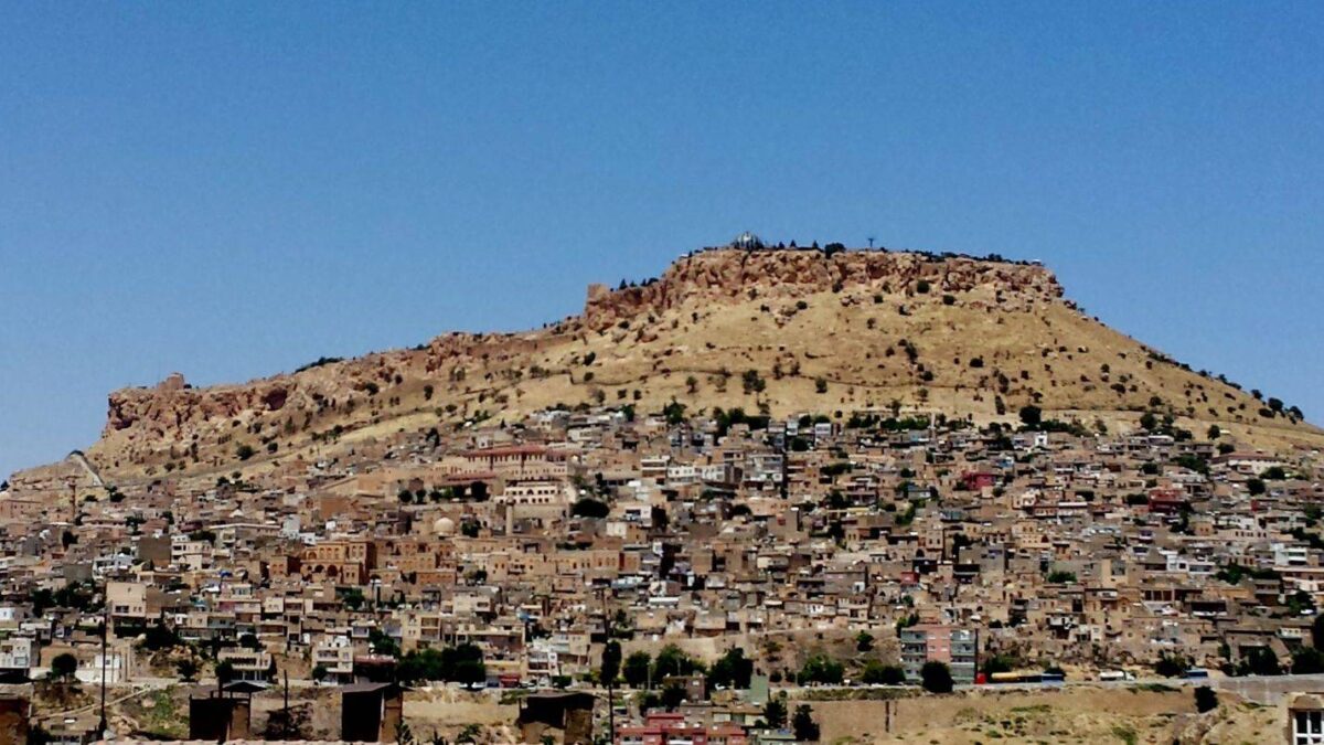Historic stone monastery building near Midyat set against a clear blue sky