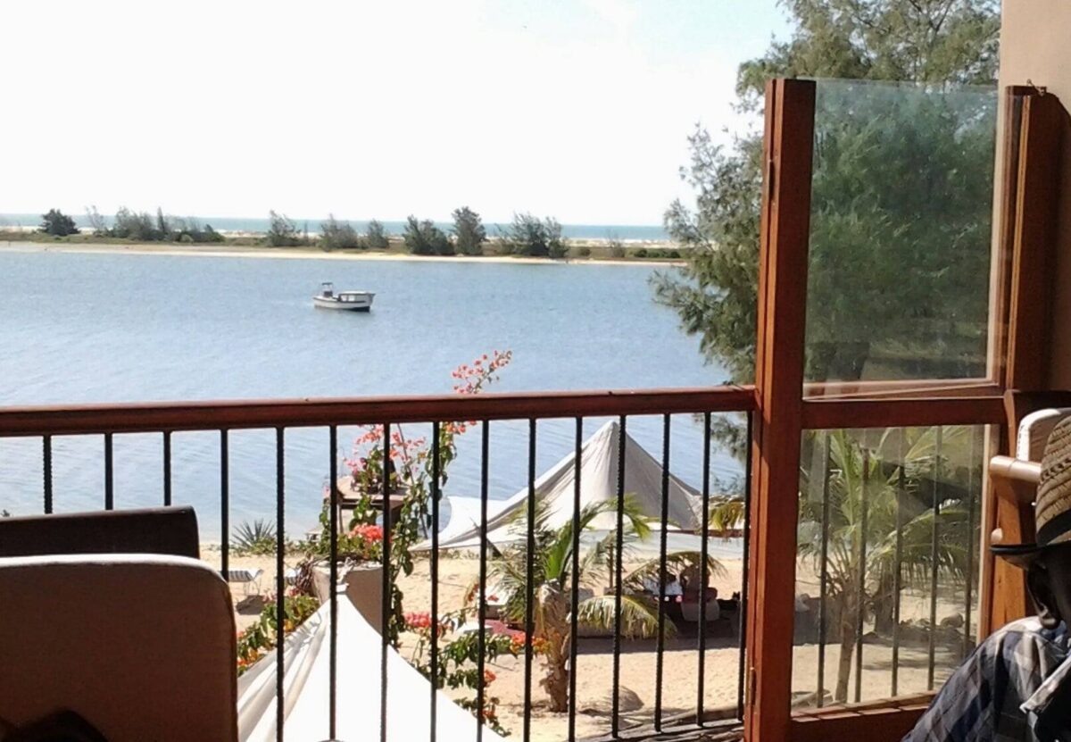 Horse-drawn carriage passing colorful colonial buildings on a street in Saint-Louis, Senegal