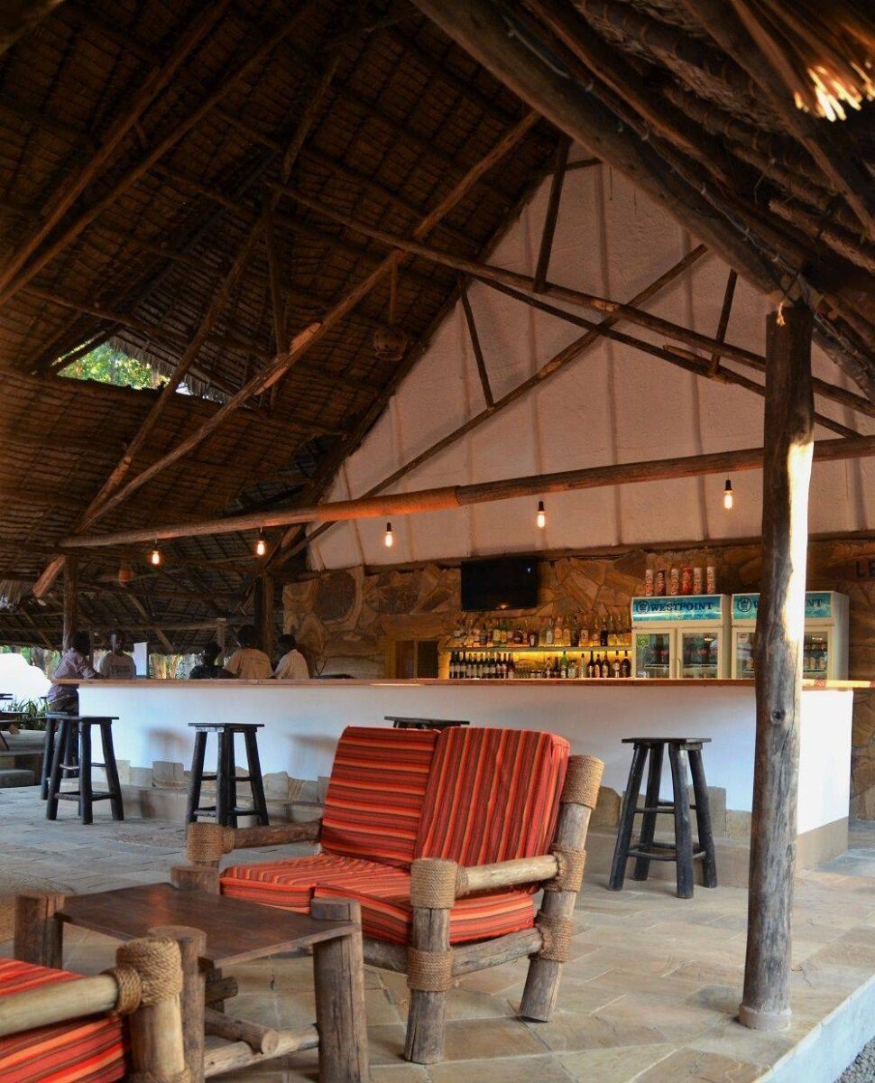 Lush garden and pool area at a lodge near Moshi with views towards Mount Kilimanjaro