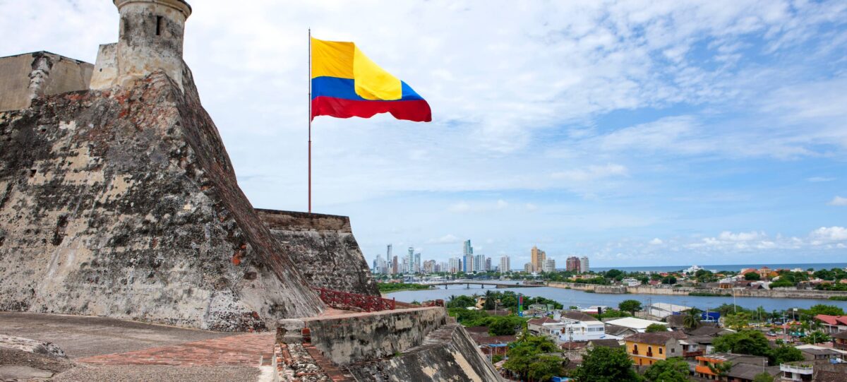 Massive stone walls and ramparts of Castillo San Felipe overlooking Cartagena’s modern skyline