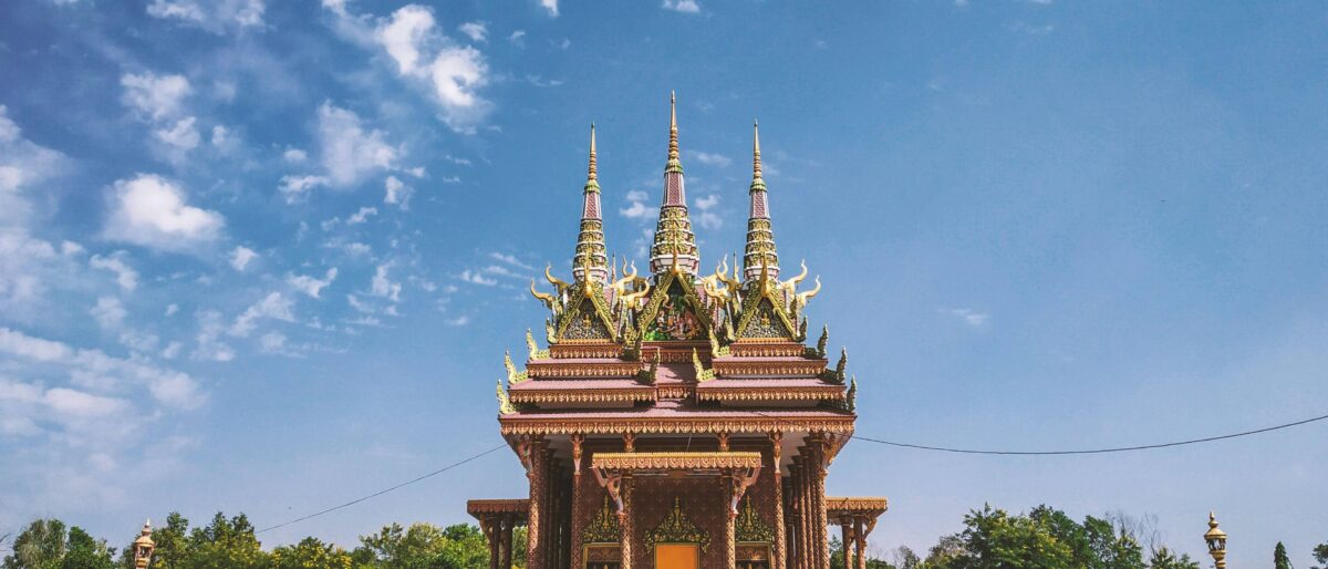 Mayadevi Temple complex in Lumbini surrounded by reflecting pool and green gardens on a clear day