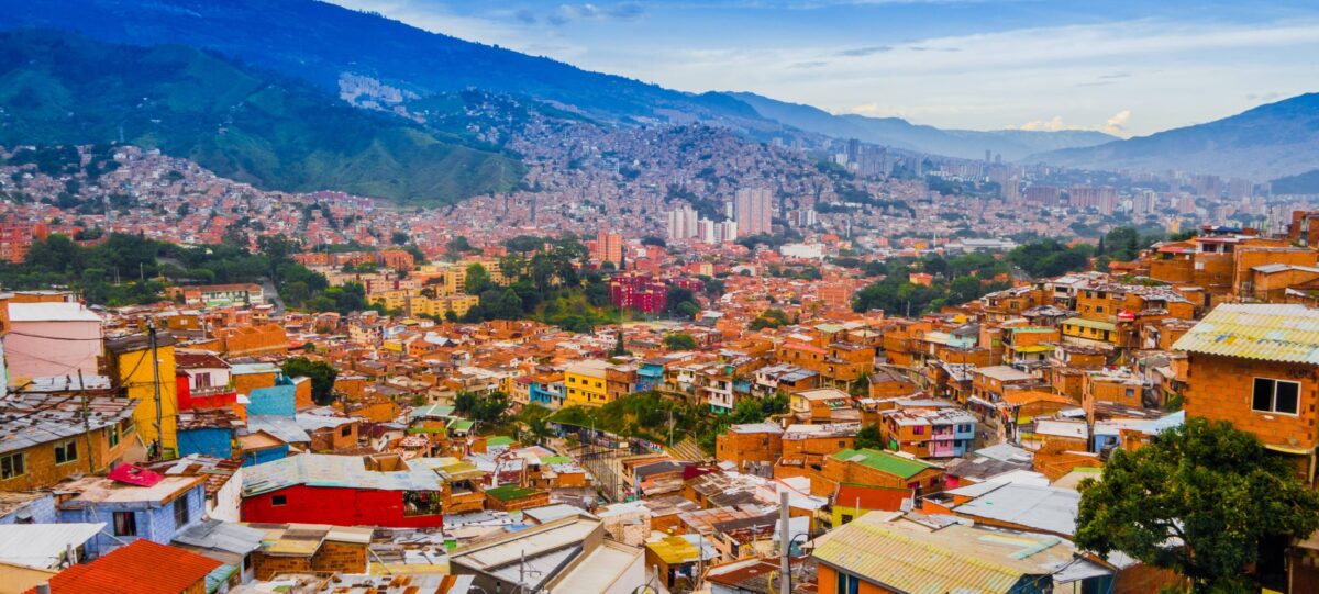 Medellín cityscape nestled in a green valley with high-rise buildings and surrounding mountains