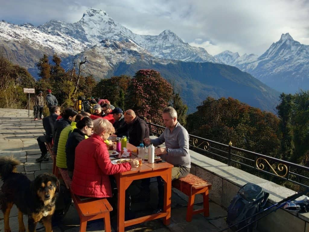 Mountain village of Ghorepani with blue-roofed teahouses and snow-capped Dhaulagiri and Annapurna peaks