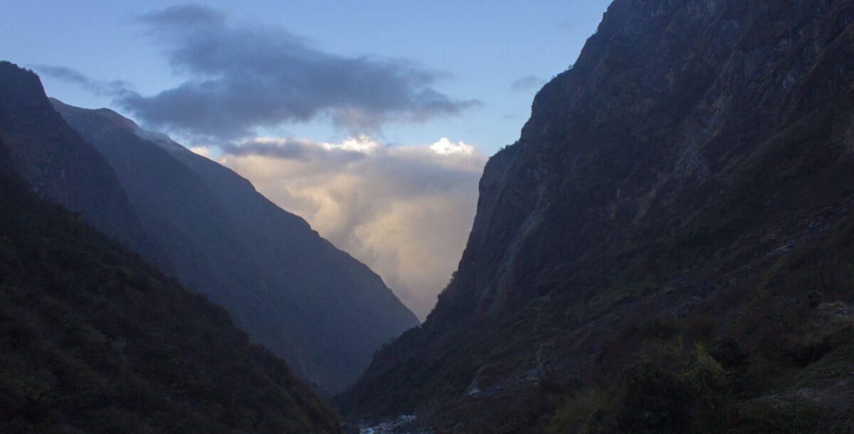 Mountain village of Pothana with stone houses and prayer flags overlooking the Annapurna range