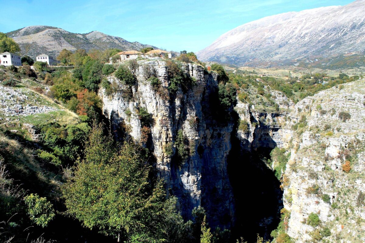 Narrow river gorge in southern Albania with clear water flowing between steep rocky cliffs
