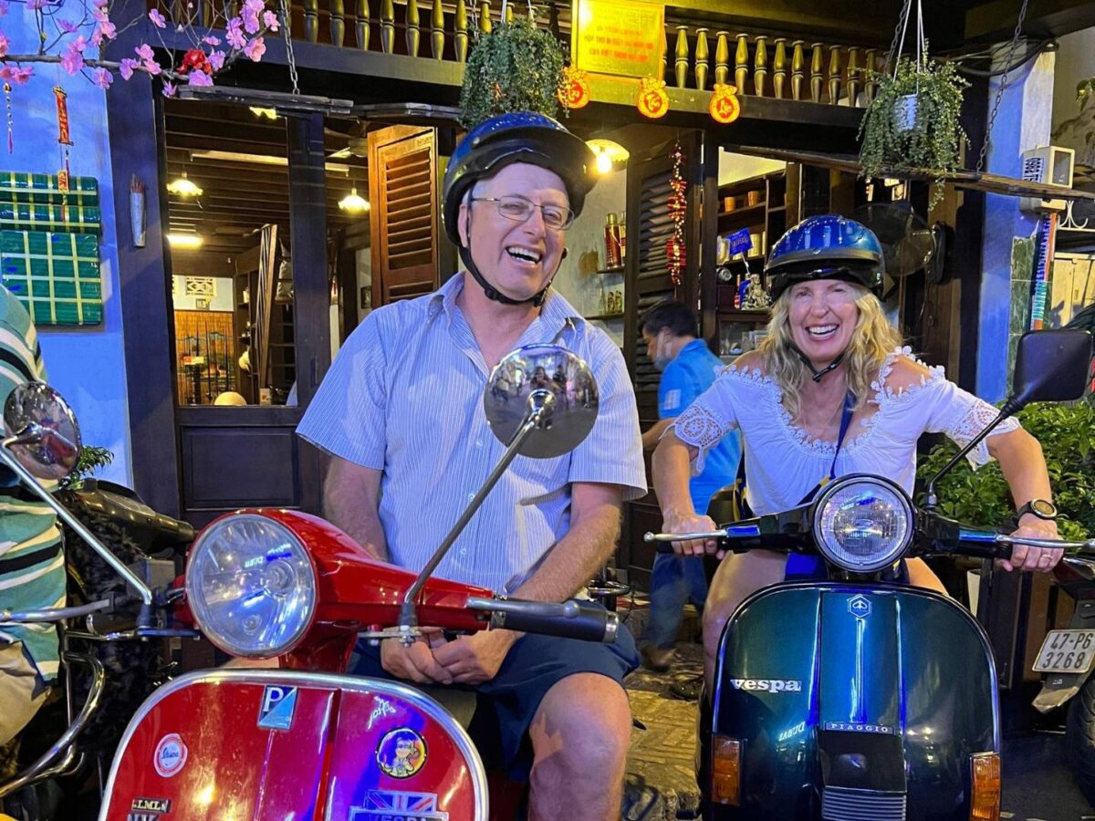 Night-time Vespa street-food tour weaving through bright neon-lit streets of Ho Chi Minh City