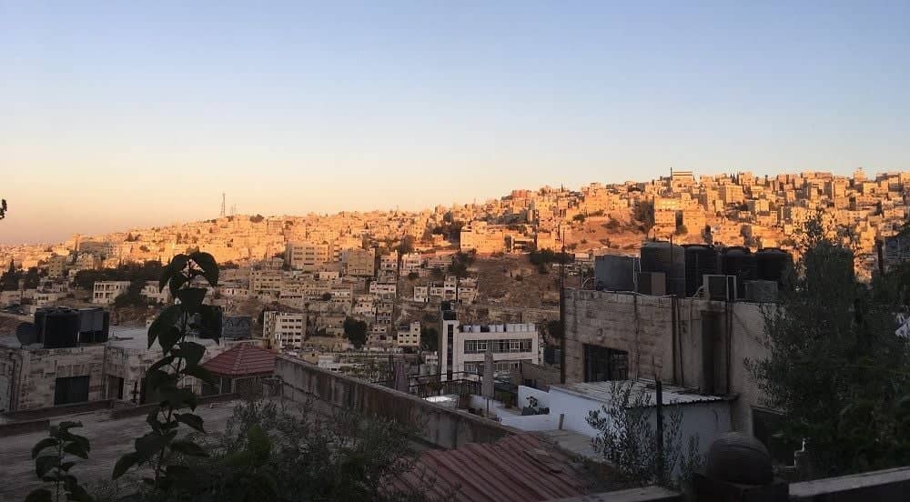Night view of Amman, Jordan with illuminated buildings and streets on the hills