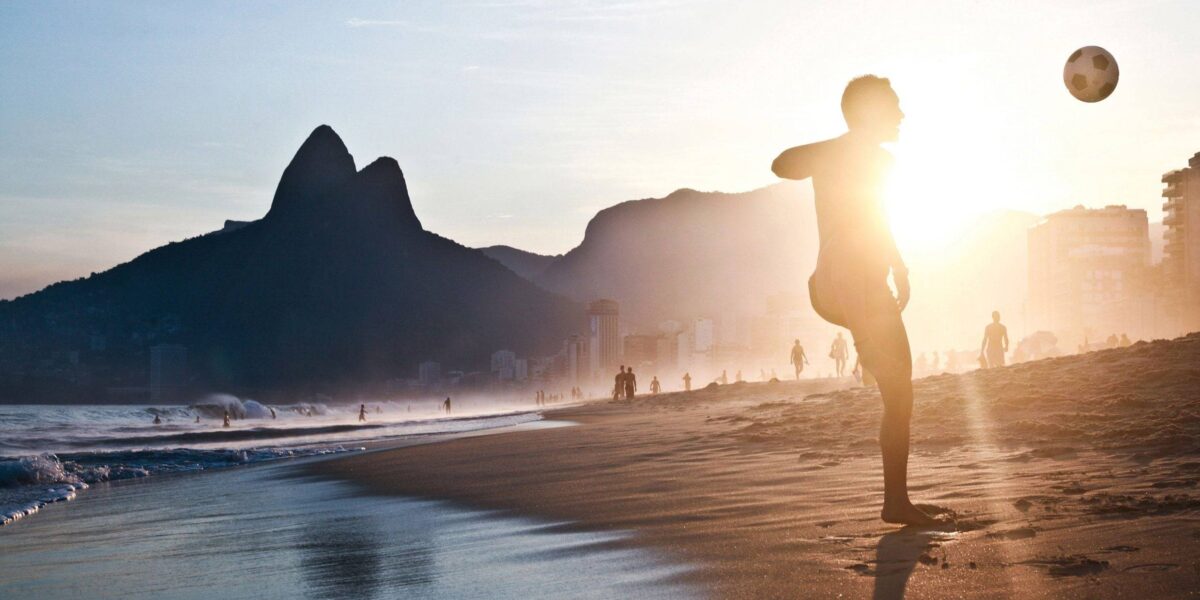 Night view of Copacabana beach in Rio de Janeiro with illuminated promenade and city skyline