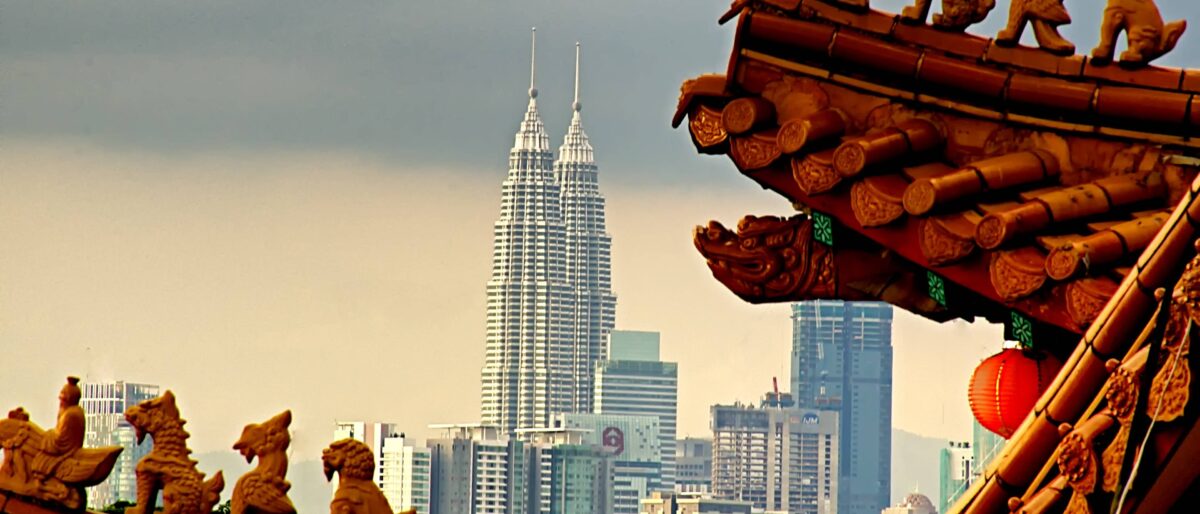 Night view of Kuala Lumpur skyline with illuminated Petronas Twin Towers and city lights
