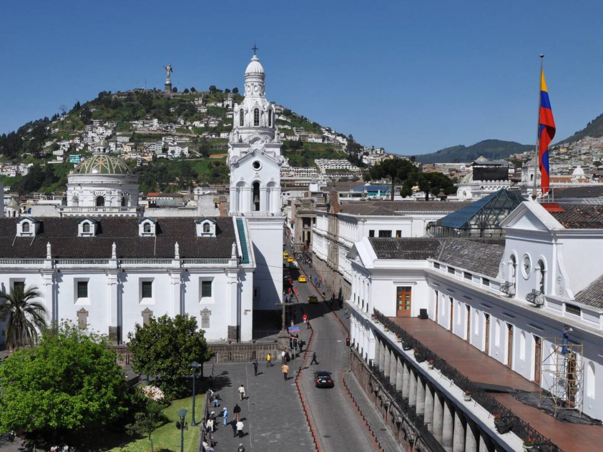Night view of Quito’s historic center with illuminated colonial churches and city lights in a mountain valley