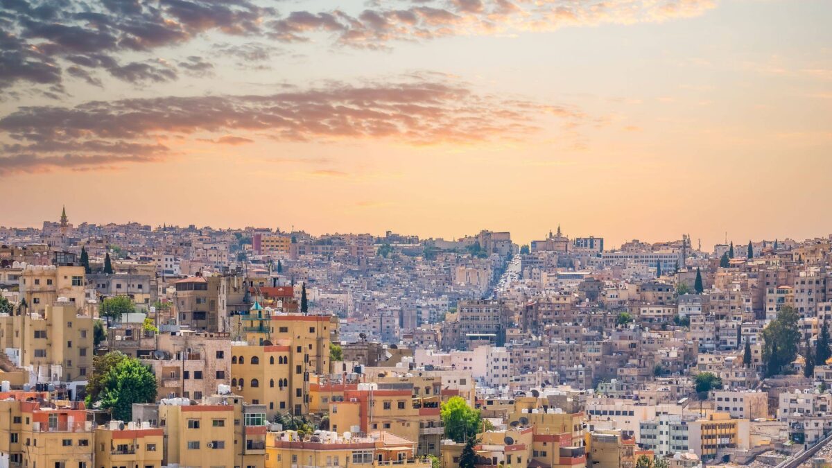 Night view over Amman with illuminated buildings welcoming travellers to Jordan