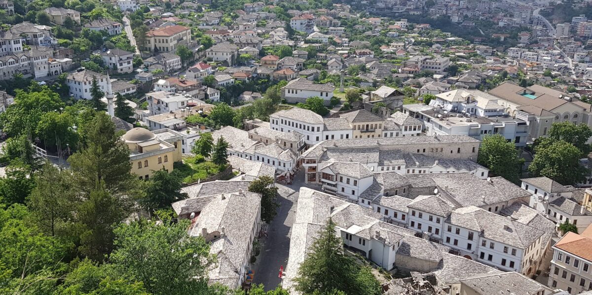 Old town of Gjirokastër with stone houses and fortress overlooking a wide valley in southern Albania